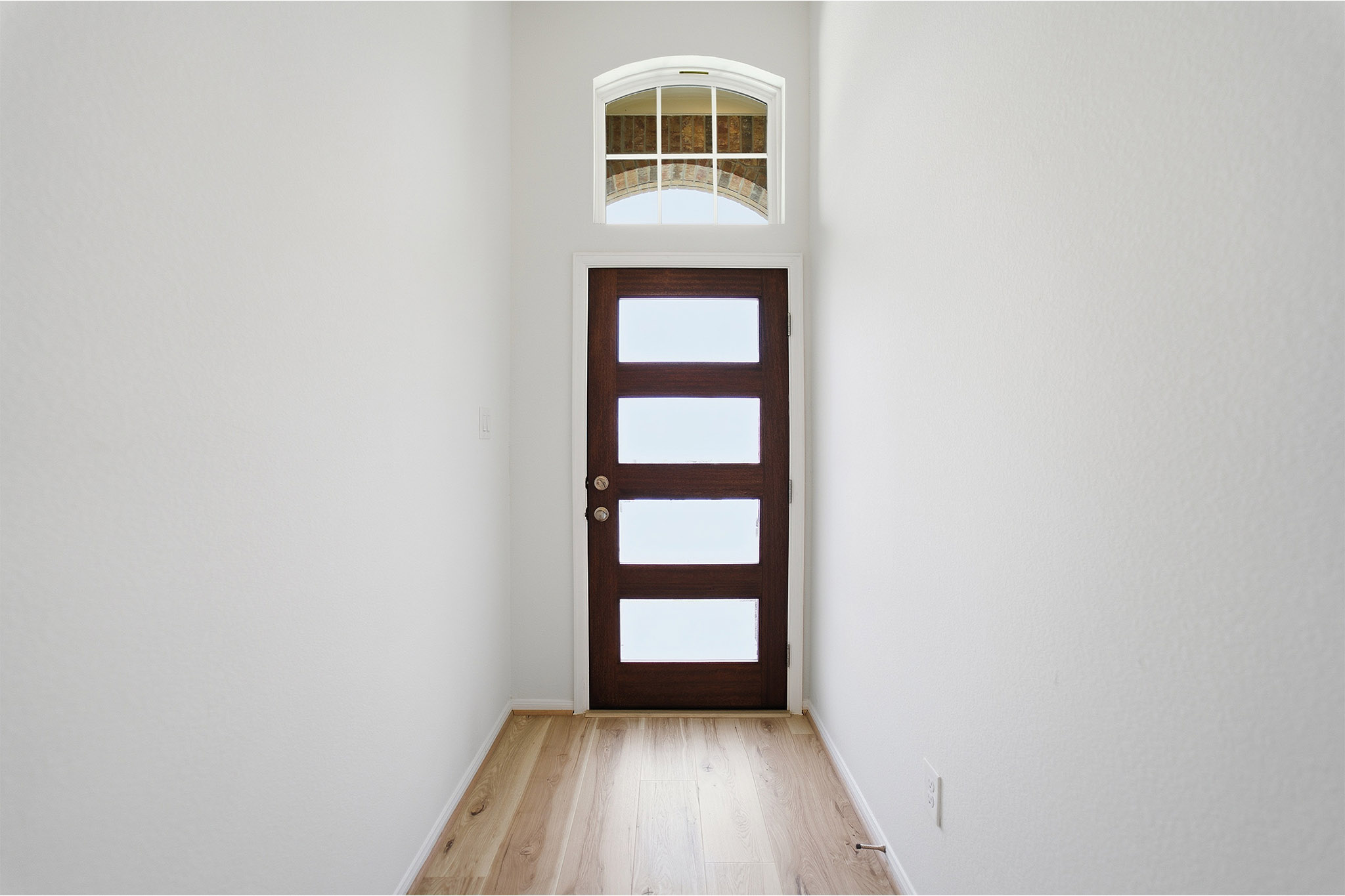 359 Grey Leaf Road Buda, TX 78610 - Photo 7 of 37 Doorway featuring wood finished floors and a high ceiling
