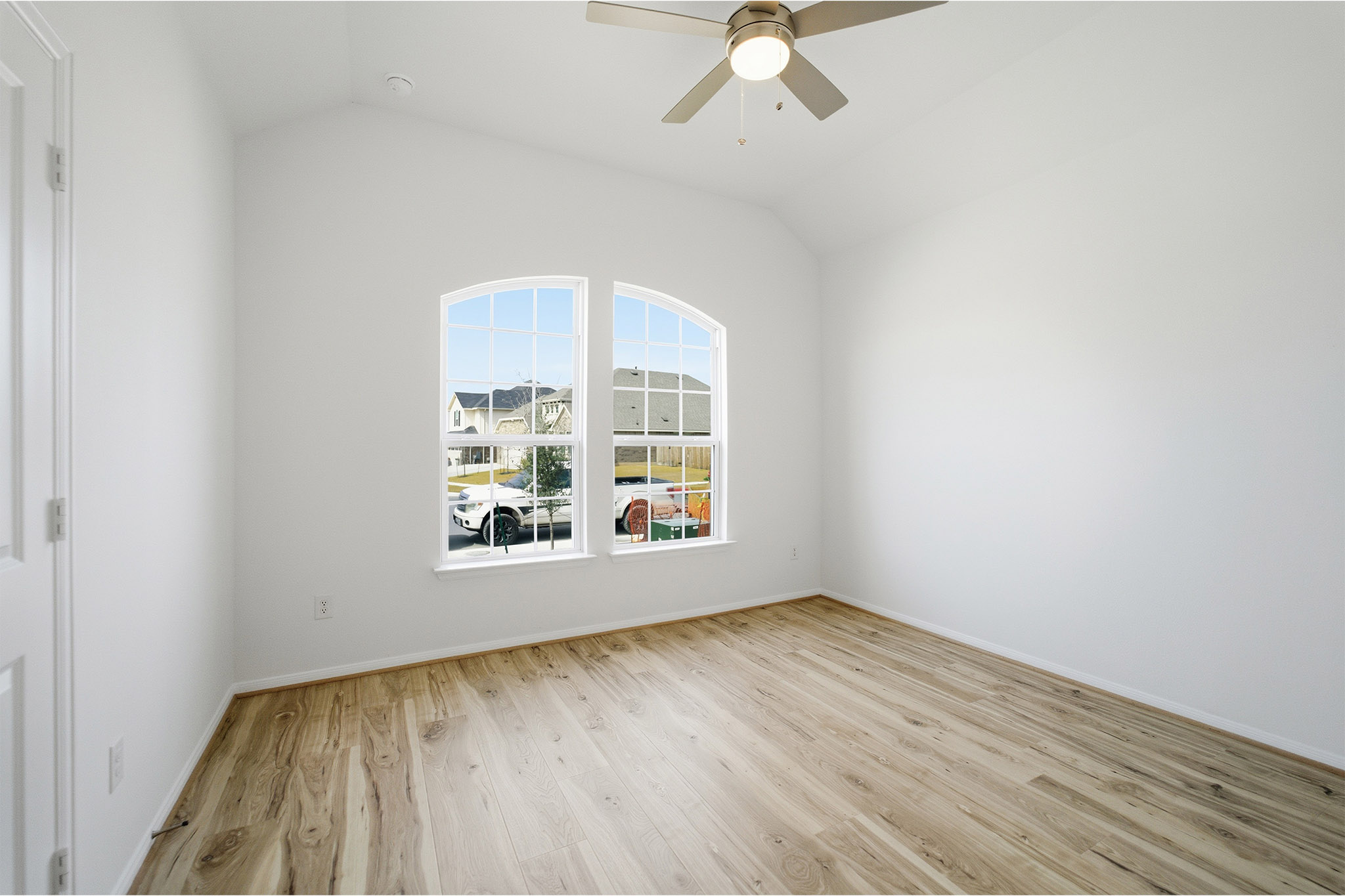 359 Grey Leaf Road Buda, TX 78610 - Photo 10 of 37 Unfurnished room featuring vaulted ceiling, light wood-style flooring, and ceiling fan