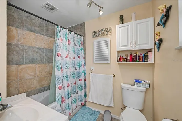 an aerial view of residential houses with outdoor space and swimming pool