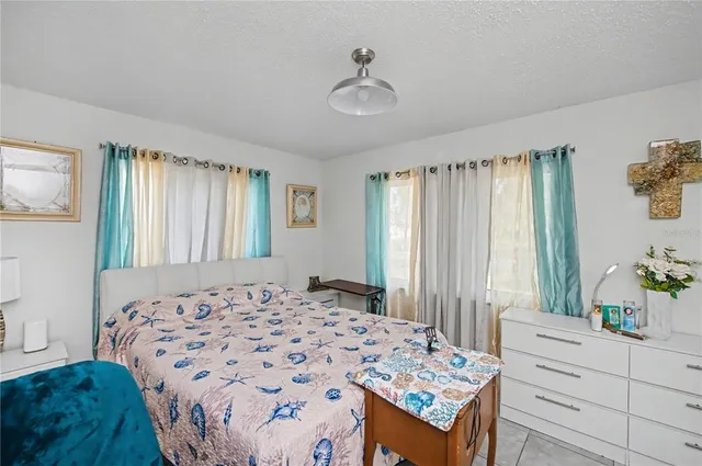 a sign that is sitting on a brick wall with a big yard