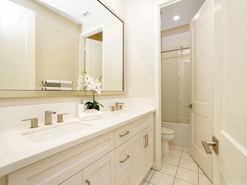 92 Iluna Irvine, CA 92618 - Photo 28 of 45 a bathroom with a sink a toilet and a mirror