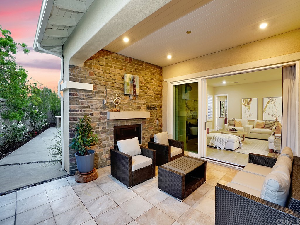 92 Iluna Irvine, CA 92618 - Photo 34 of 45 a dining room with furniture and a fireplace