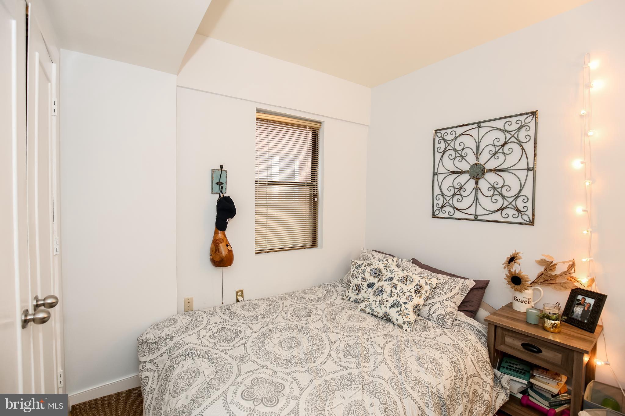 1727 R Street Northwest, Unit 203 Washington, DC 20009 - Photo 11 of 14 a bedroom with a bed and a lamp on dresser
