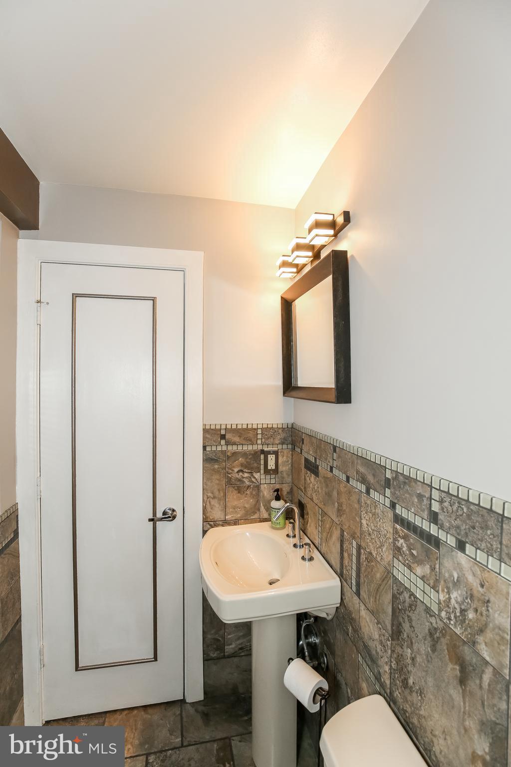 1727 R Street Northwest, Unit 203 Washington, DC 20009 - Photo 13 of 14 a bathroom with a sink mirror and toilet