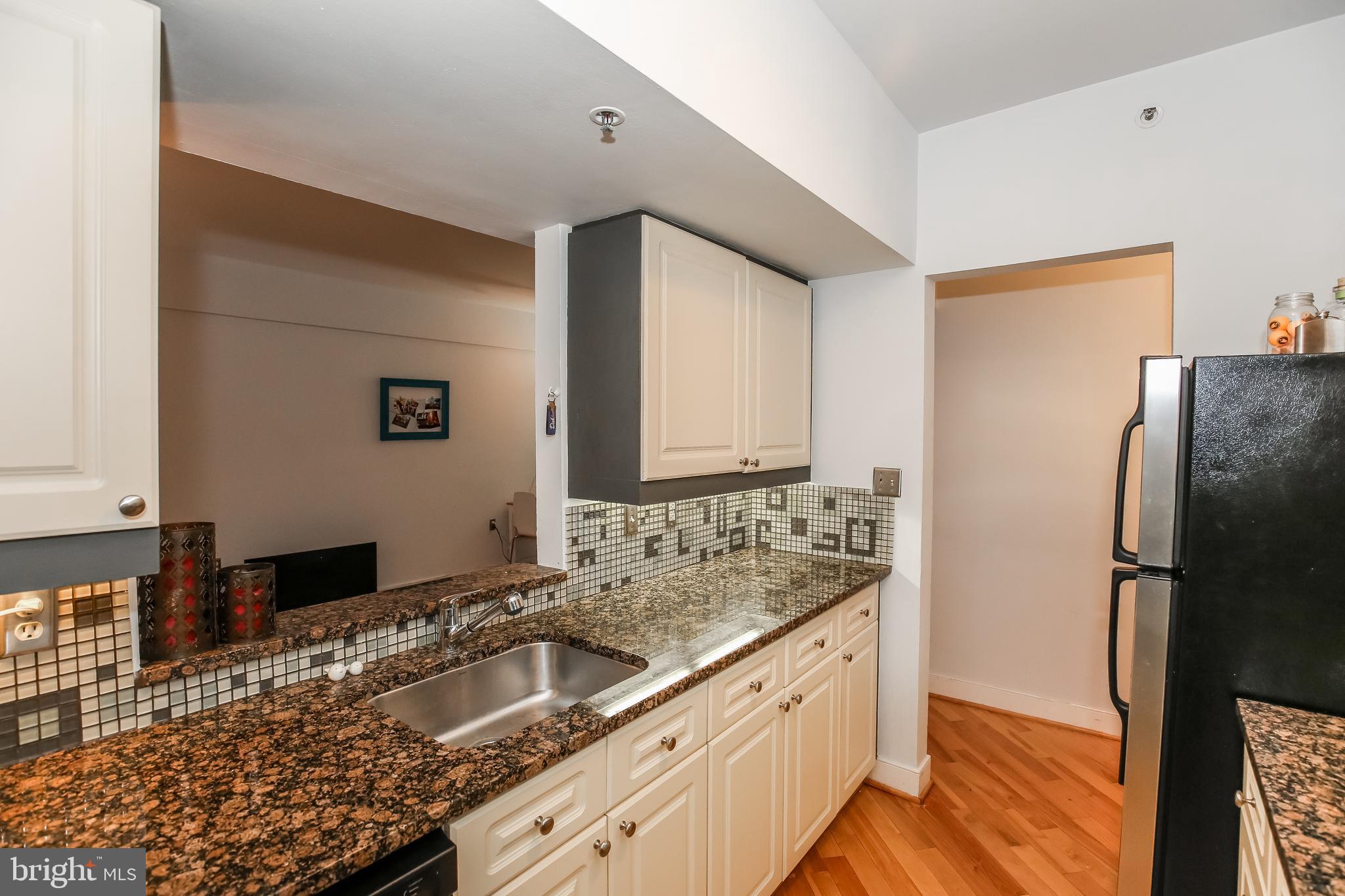 1727 R Street Northwest, Unit 203 Washington, DC 20009 - Photo 9 of 14 a bathroom with a granite countertop double vanity sink and mirror