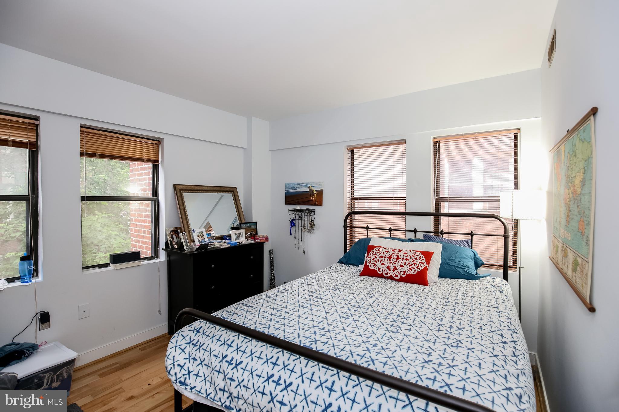 1727 R Street Northwest, Unit 203 Washington, DC 20009 - Photo 10 of 14 a bedroom with a bed and wooden floor