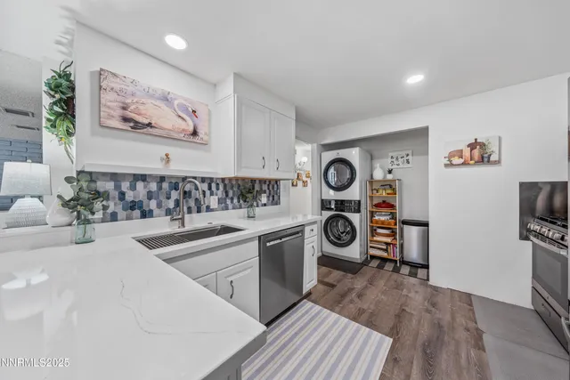 a kitchen with stainless steel appliances a stove a sink and a refrigerator