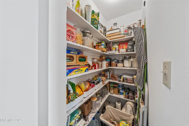a view of a patio with a table and chairs and potted plants