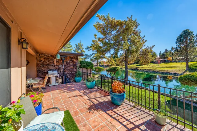 a view of a house with wooden floor and a fence