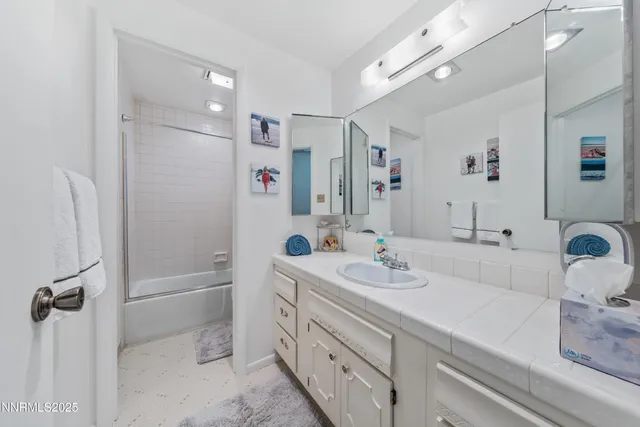 a bathroom with a double vanity sink mirror double and shower