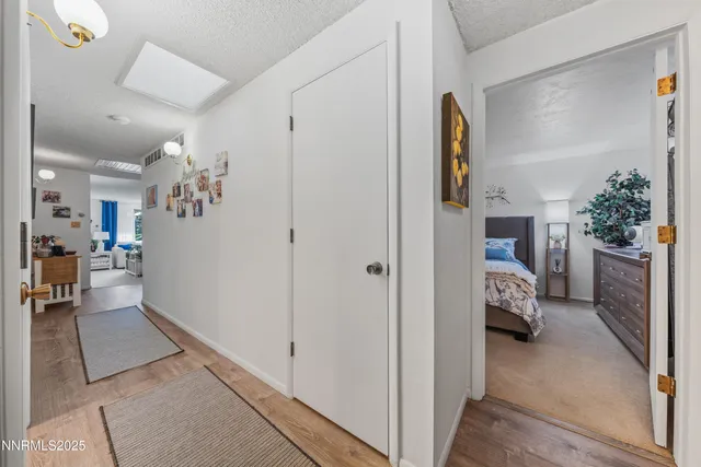 a view of hallway with livingroom and furniture