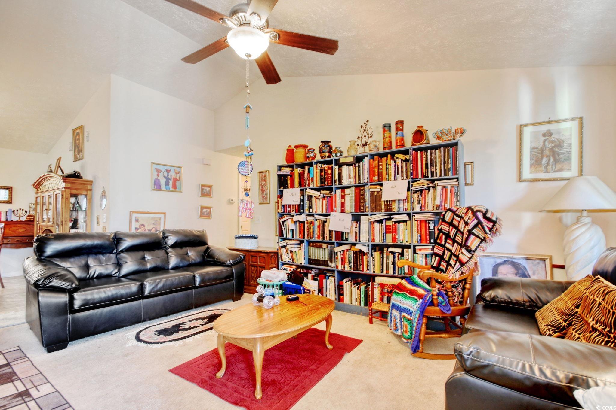 719 American Beech Street Loris, SC 29569 - Photo 4 of 20 Living room featuring carpet floors, a textured ceiling, vaulted ceiling, and ceiling fan