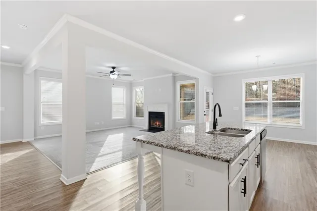 a kitchen with granite countertop kitchen island sink stove and granite counter tops