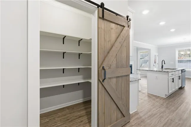 a kitchen with white cabinets and refrigerator