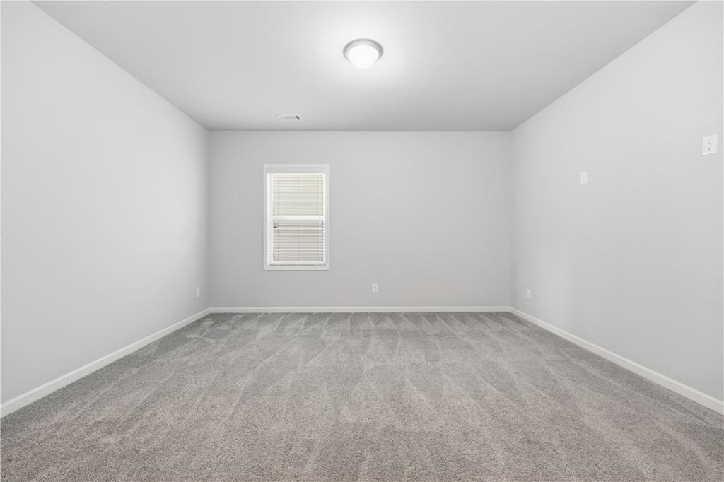 3244 Hawthorne Path Braselton, GA 30517 - Photo 24 of 48 a view of an empty room with a window