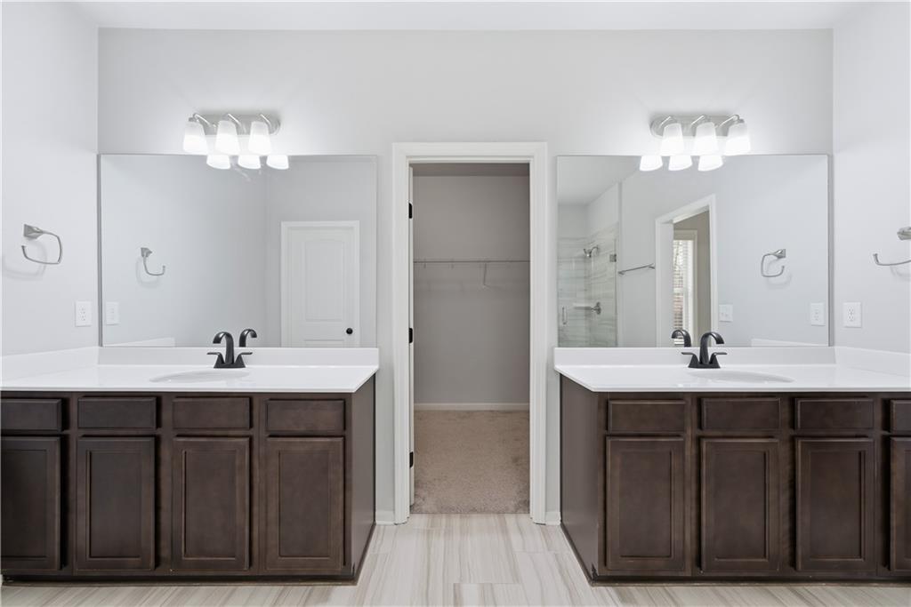 3244 Hawthorne Path Braselton, GA 30517 - Photo 31 of 48 a bathroom with a sink double vanity and a mirror