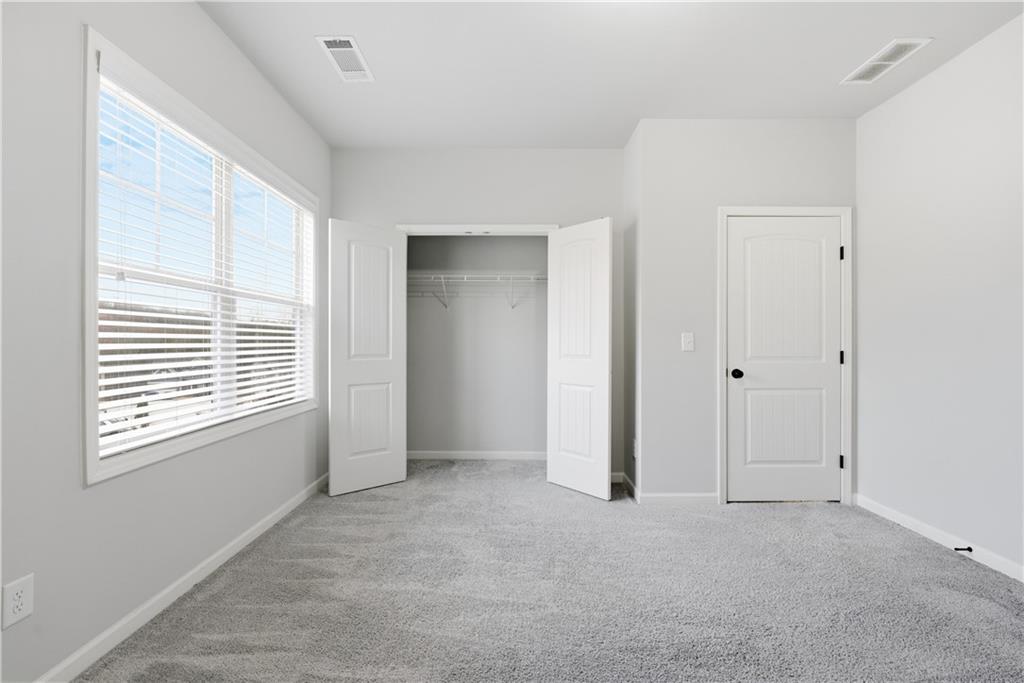 3244 Hawthorne Path Braselton, GA 30517 - Photo 34 of 48 a view of an empty room with a window