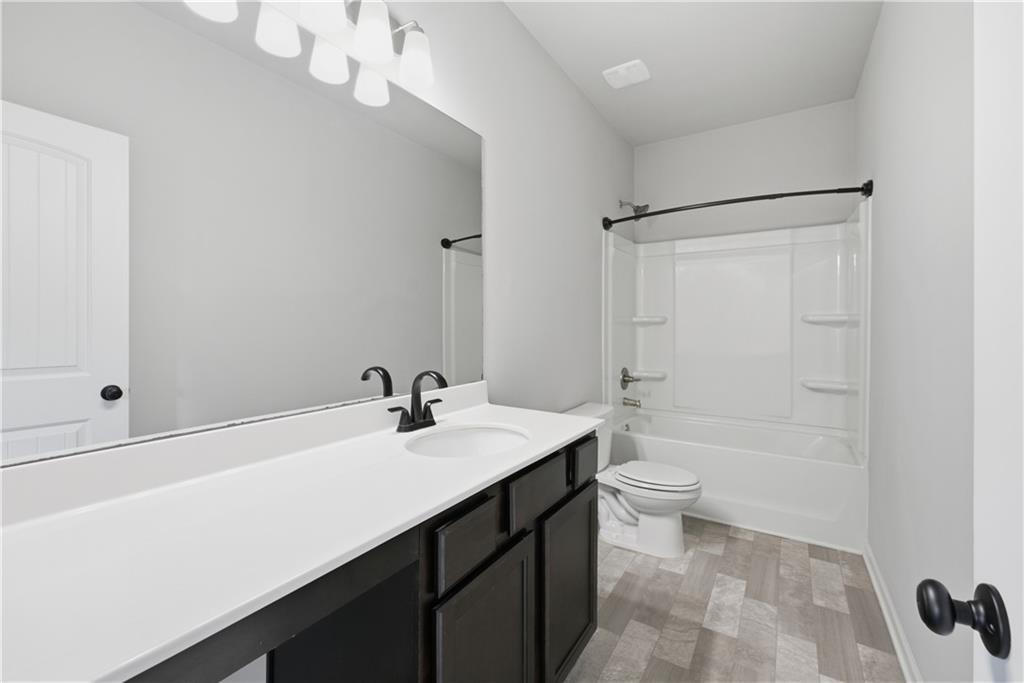 3244 Hawthorne Path Braselton, GA 30517 - Photo 38 of 48 a bathroom with a sink a toilet and shower