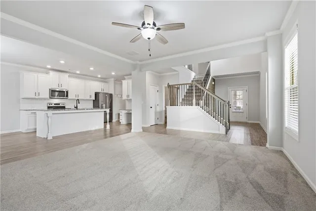 a view of a kitchen with a sink and a refrigerator
