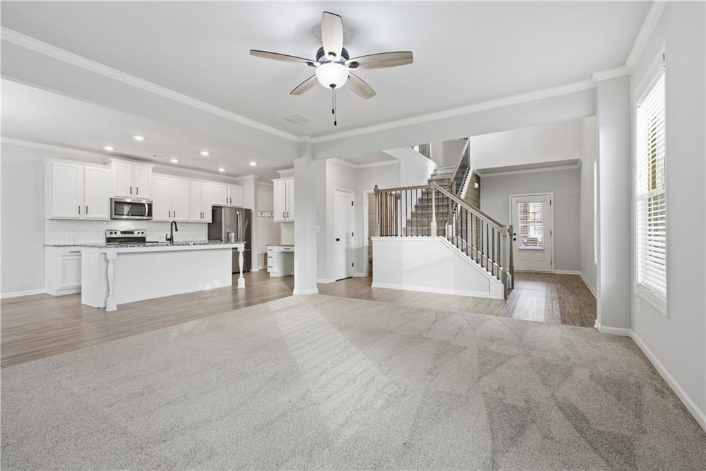 3244 Hawthorne Path Braselton, GA 30517 - Photo 8 of 48 a view of a kitchen with a sink and a refrigerator