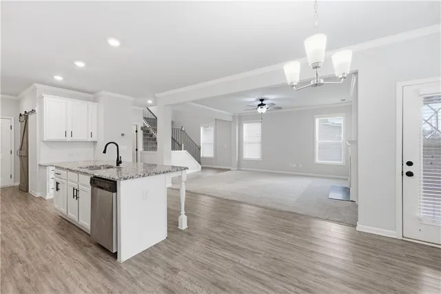 a view of kitchen with sink microwave and stove