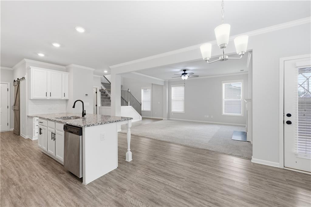 3244 Hawthorne Path Braselton, GA 30517 - Photo 10 of 48 a view of kitchen with sink microwave and stove