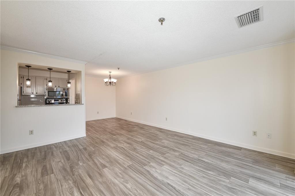 300 Johnson Ferry Road, Unit A612 Atlanta, GA 30328 - Photo 1 of 1 an empty room with wooden floor and windows