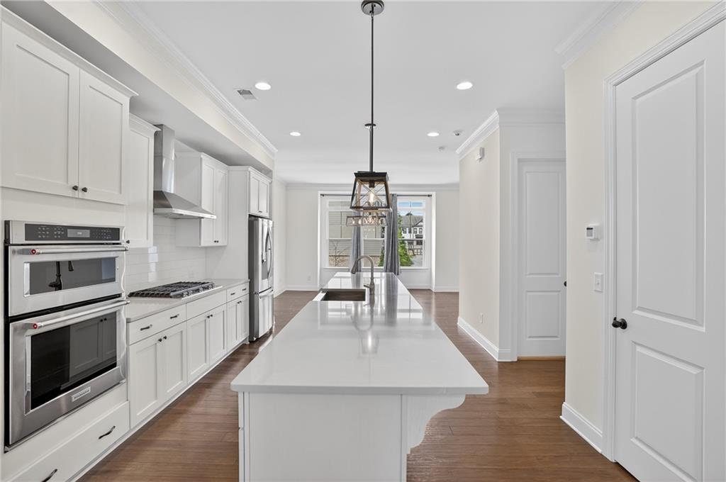 2341 Medlock Lane Decatur, GA 30033 - Photo 11 of 37 a kitchen with white cabinets and stainless steel appliances