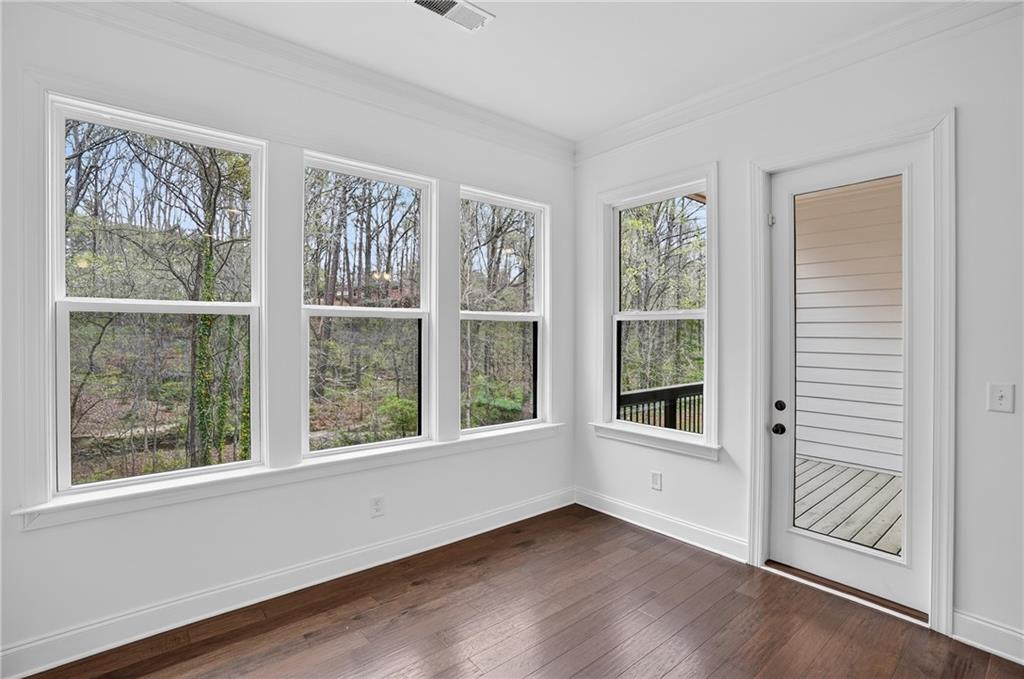 2341 Medlock Lane Decatur, GA 30033 - Photo 15 of 37 a view of an empty room with a window and wooden floor