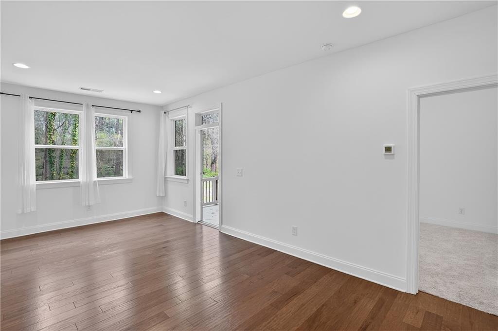 2341 Medlock Lane Decatur, GA 30033 - Photo 19 of 37 a view of an empty room with wooden floor and windows