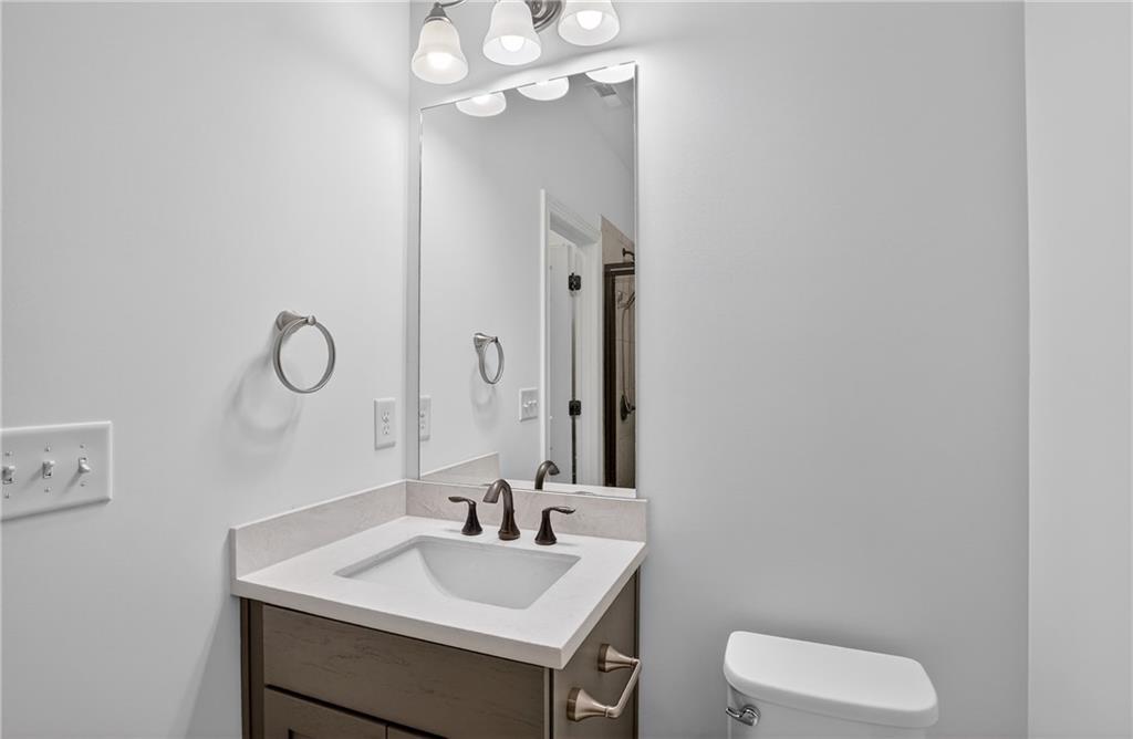 2341 Medlock Lane Decatur, GA 30033 - Photo 23 of 37 a bathroom with a toilet sink vanity and mirror