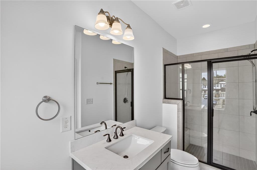 2341 Medlock Lane Decatur, GA 30033 - Photo 28 of 37 a bathroom with a sink vanity mirror and toilet