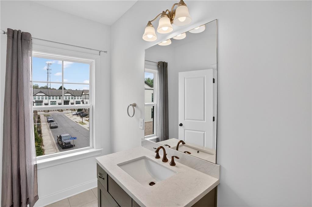 2341 Medlock Lane Decatur, GA 30033 - Photo 29 of 37 a bathroom with a sink a large mirror and vanity