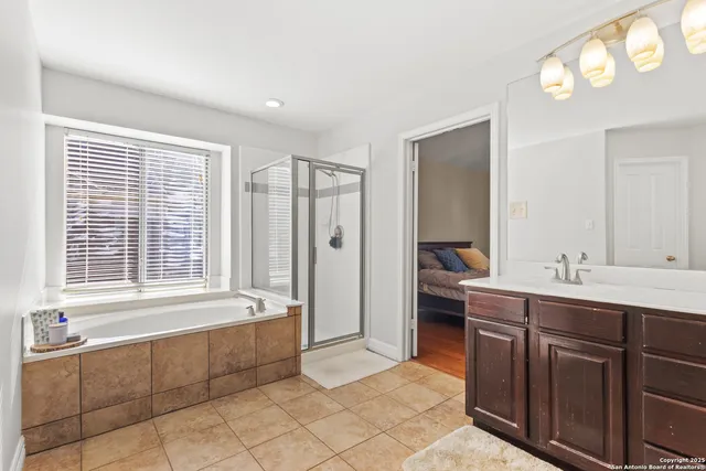 a spacious bathroom with a double vanity sink and a mirror
