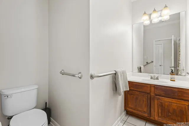 a bathroom with a toilet a sink and mirror