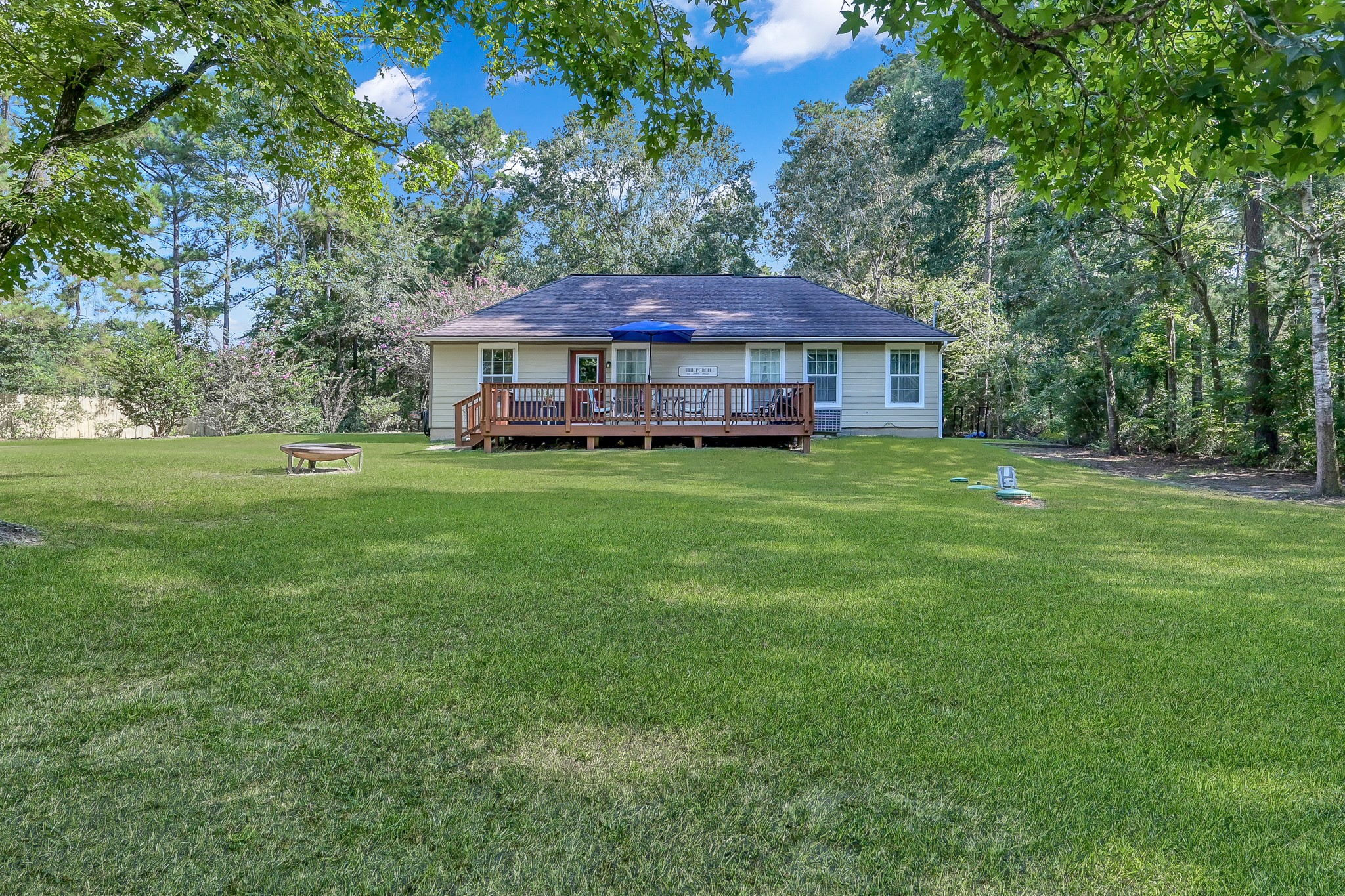 261 Franklyn Road Coldspring, TX 77331 - Photo 18 of 19 Spacious backyard with a deck, all set on a generous 0.83-acre lot.
