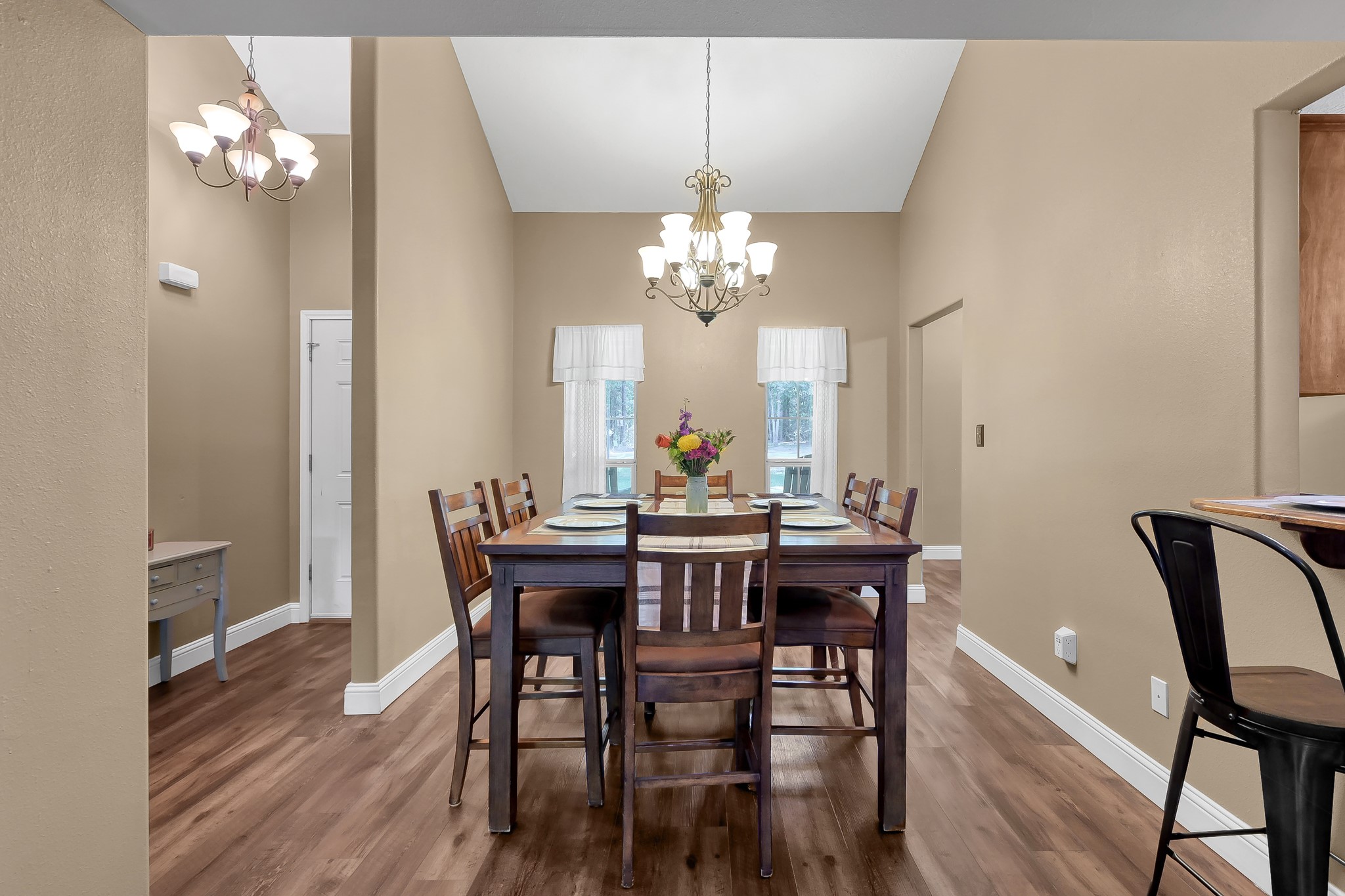 261 Franklyn Road Coldspring, TX 77331 - Photo 2 of 19 Bright dining room with high ceilings, elegant chandelier, and windows that overlook the scenic front yard.
