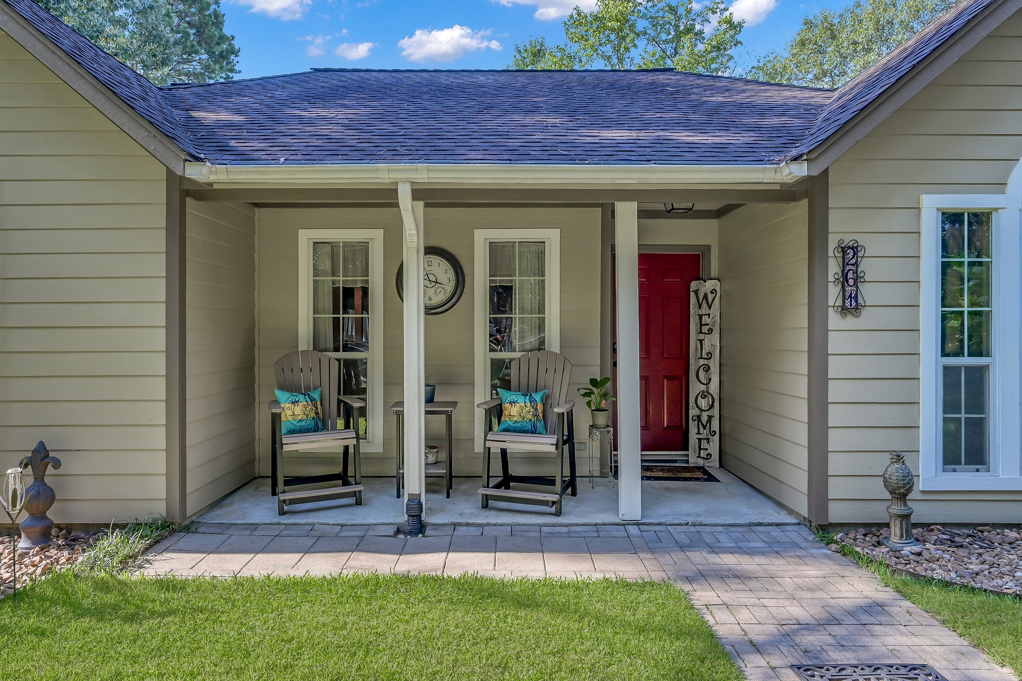 261 Franklyn Road Coldspring, TX 77331 - Photo 3 of 19 Inviting front porch with seating area and a bold red door that creates a warm welcome.