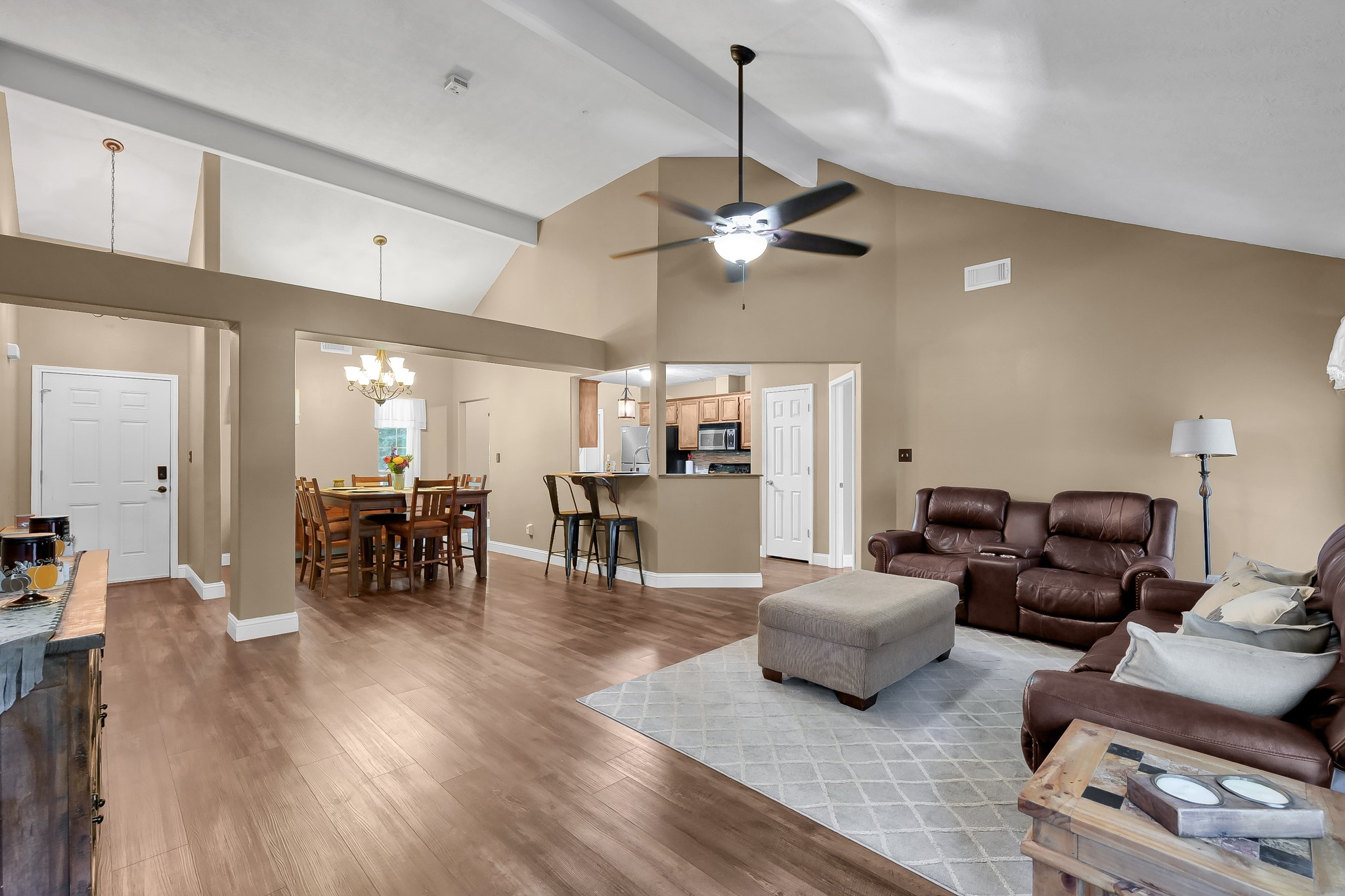 261 Franklyn Road Coldspring, TX 77331 - Photo 5 of 19 Spacious open-concept living and dining area with vaulted ceilings, upgraded vinyl plank flooring, and fresh paint throughout, creating a warm and inviting space perfect for gatherings.