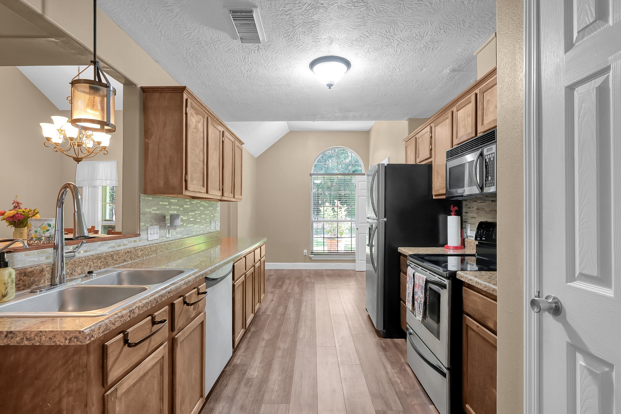 261 Franklyn Road Coldspring, TX 77331 - Photo 8 of 19 Spacious kitchen with stainless appliances, ample cabinetry, and pantry, opening to a bright dining area. Laundry room with washer & dryer just off to the side.