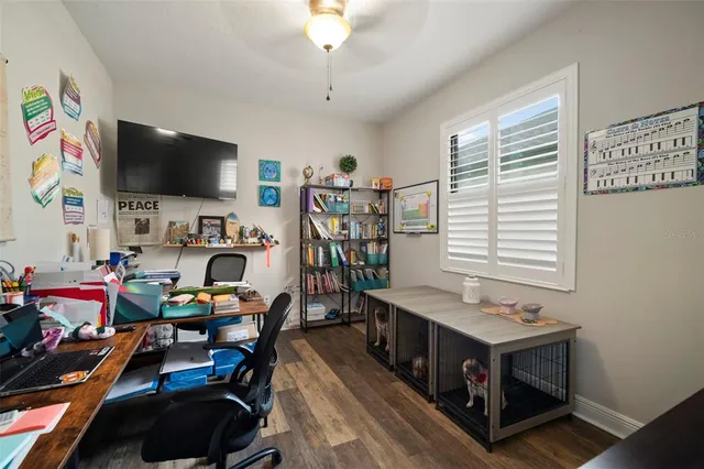 a view of a livingroom with workspace and a couch