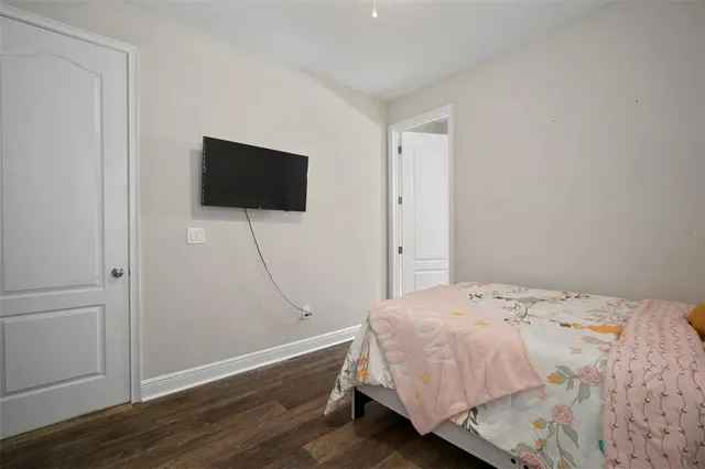 a bed sitting in a bedroom next to a window