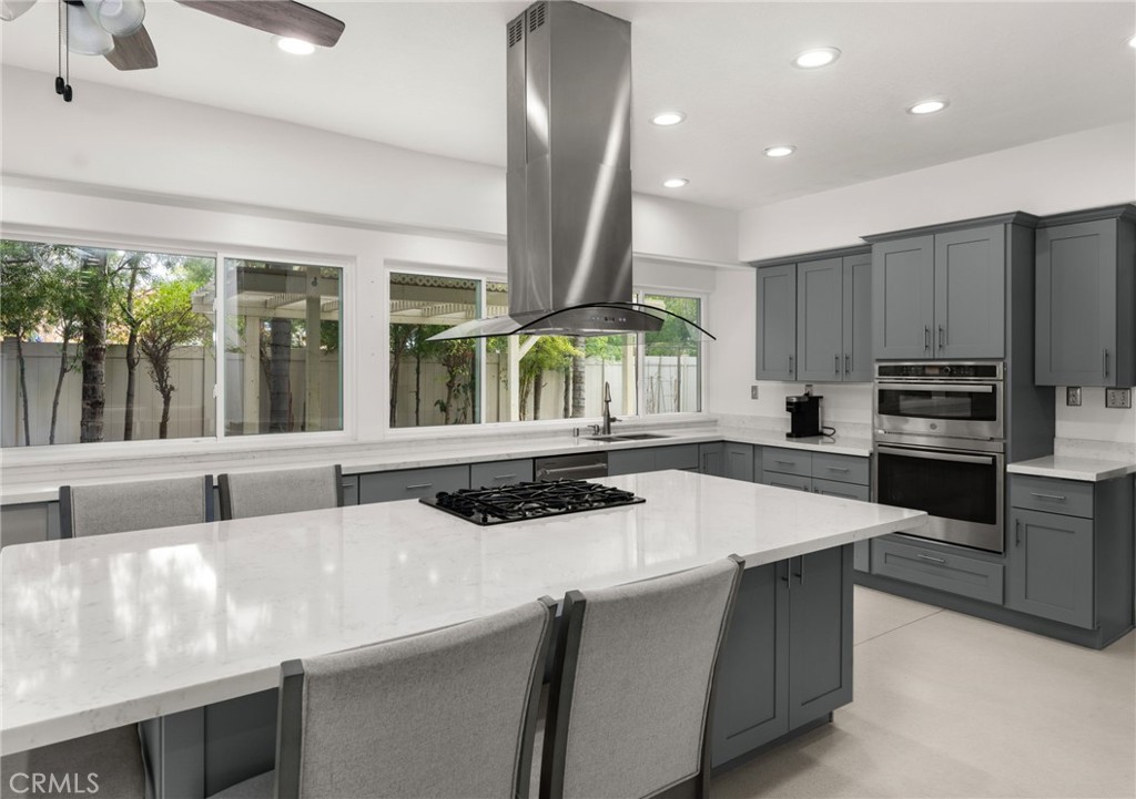 1015 La Salle Circle Corona, CA 92879 - Photo 16 of 56 a kitchen with stainless steel appliances kitchen island granite countertop a sink and counter space