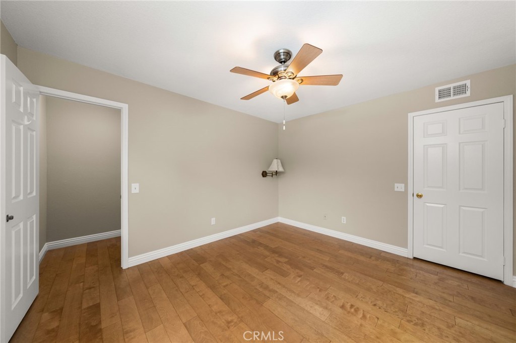 1015 La Salle Circle Corona, CA 92879 - Photo 28 of 56 a view of a room with wooden floor and a ceiling fan