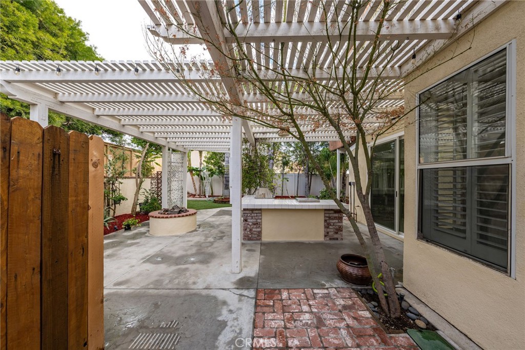1015 La Salle Circle Corona, CA 92879 - Photo 38 of 56 a view of a patio with table and chairs and wooden fence with plants