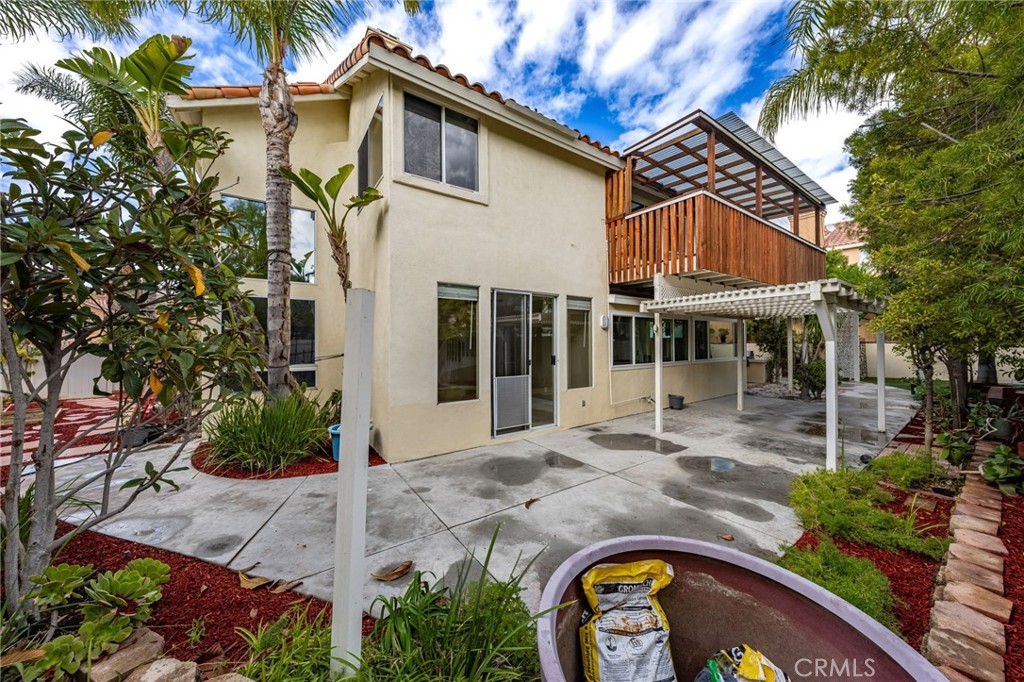 1015 La Salle Circle Corona, CA 92879 - Photo 46 of 56 a view of a white house with large windows and flower plants