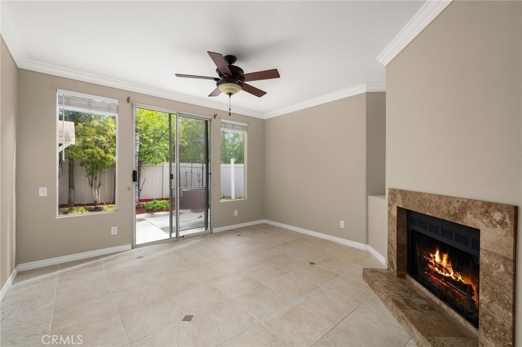 1015 La Salle Circle Corona, CA 92879 - Photo 8 of 56 a view of an empty room with windows and a fireplace