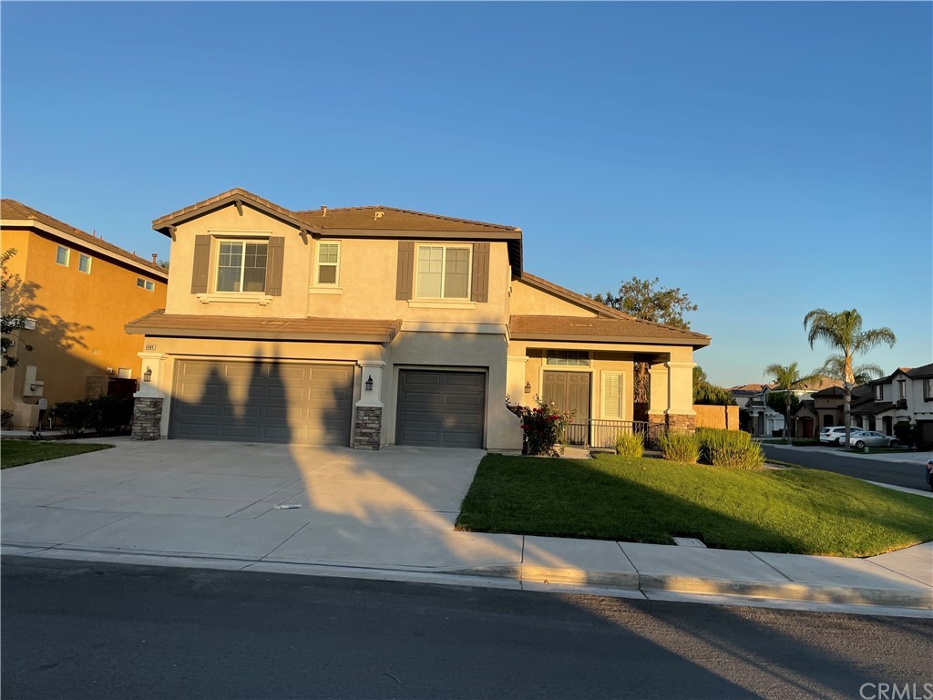 6884 Raspberry Court Eastvale, CA 92880 - Photo 1 of 1 a front view of a house with a yard