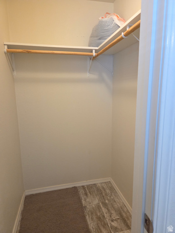 1275 Thrush Road Salt Lake City, UT 84123 - Photo 16 of 20 Walk-in closet featuring white shelving, a wood hanging rod, carpeted