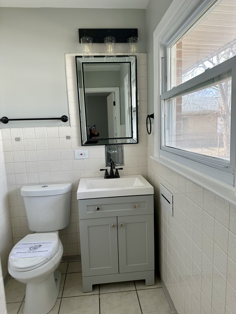 Undisclosed Address Glenwood, IL 60425 - Photo 12 of 17 a bathroom with a toilet sink and mirror
